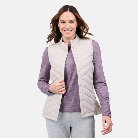 [Emily is 5'9" wearing size S] Woman wearing a light gray quilted vest over a purple long-sleeve shirt on a white background