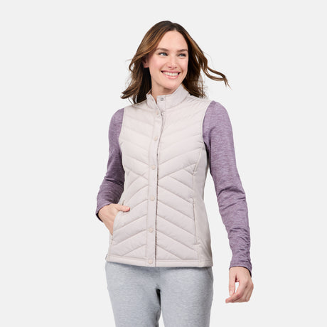 [Emily is 5'9" wearing size S] Woman wearing a light gray quilted vest over a purple long-sleeve shirt on a white background 