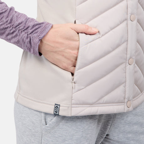 [Emily is 5'9" wearing size S] Person wearing a light gray quilted vest with a brand logo on a plain background
