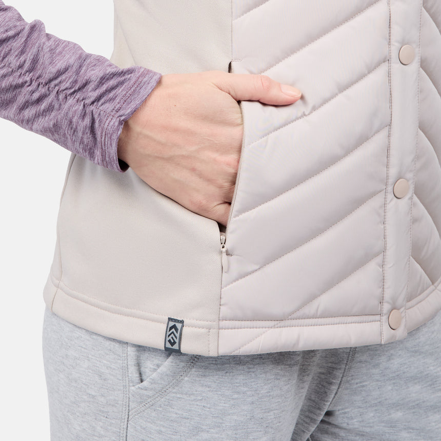 [Emily is 5'9" wearing size S] Person wearing a light gray quilted vest with a brand logo on a plain background
