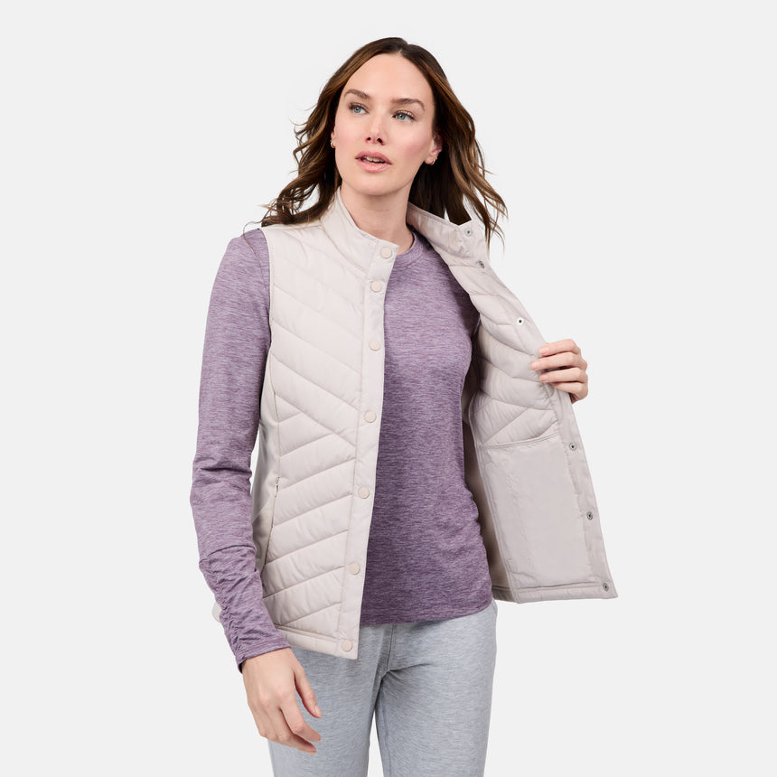 [Emily is 5'9" wearing size S] Woman wearing a light purple sweater and gray puffer vest on a white background