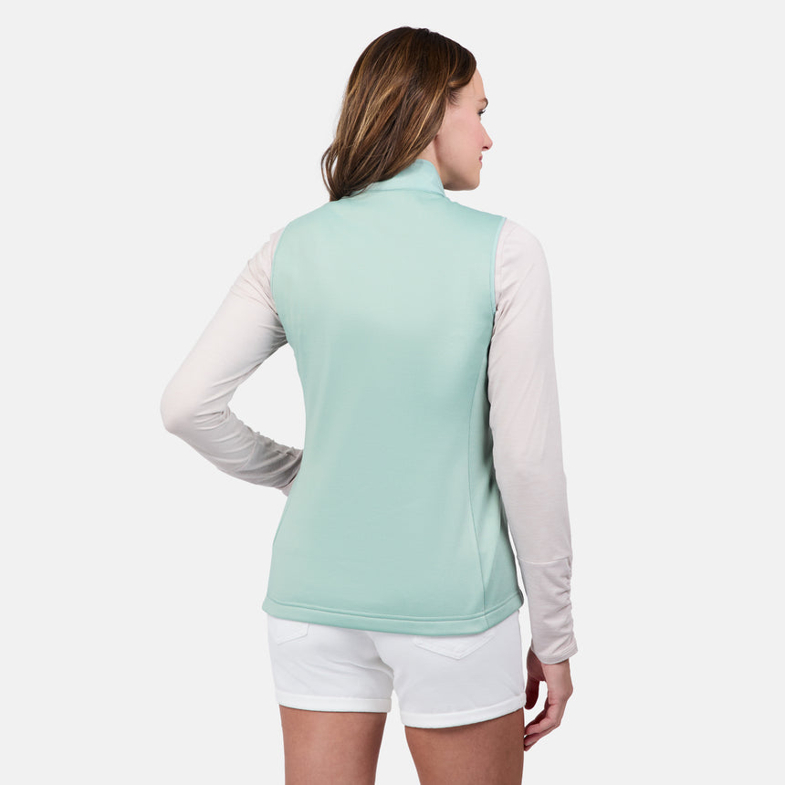 [Emily is 5'9" wearing size S] Woman wearing a light green vest over a white long-sleeve shirt and white shorts on a white background