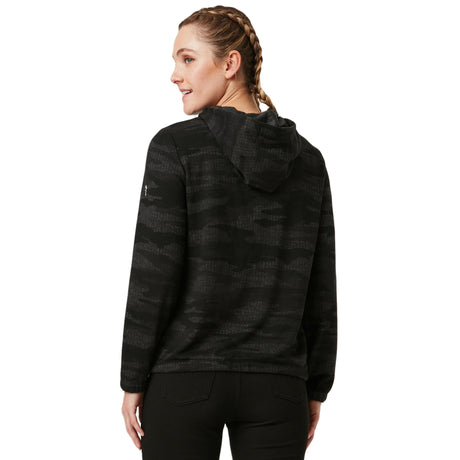 A person with braided hair is seen from the back wearing the Women's Luxe Easy Fit Pullover by Clearance, featuring a black and dark gray camouflage pattern, breathable fabric, and paired with black pants.