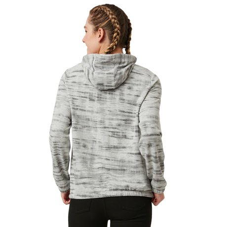 A person with braided hair is seen from the back, wearing the Women's Luxe Easy Fit Pullover by Clearance in a gray and white tie-dye pattern, paired with black pants against a plain white backdrop.