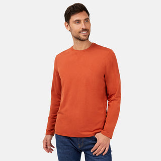A man in the Free Country Men's FreeCycle® Sueded Melange Long Sleeve Crew Neck and blue jeans stands against a light gray background, looking slightly left and smiling.