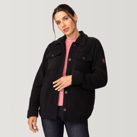[Olga is 5’9" wearing a size Small.] Woman wearing Free Country Women's Sherpa Shacket in black with a full front button opening, stand collar, chest pockets, and soft sherpa fabric. light grey background. Perfect women’s jacket for fall weather.