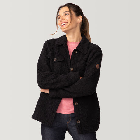 [Olga is 5’9" wearing a size Small.] Woman wearing Free Country Women's Sherpa Shacket in black with a full front button opening, stand collar, chest pockets, and soft sherpa fabric. light grey background. Perfect women’s jacket for fall weather.