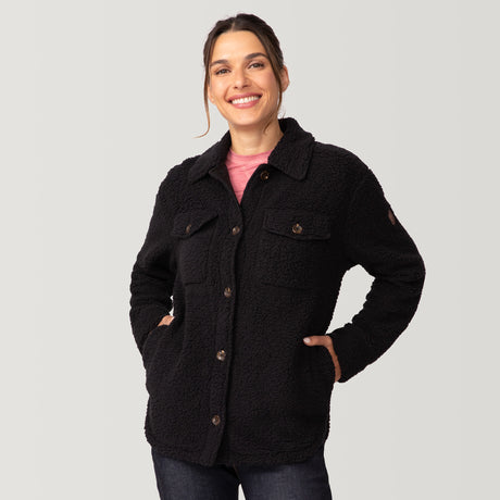 [Olga is 5’9" wearing a size Small.] Woman wearing Free Country Women's Sherpa Shacket in black with a full front button opening, stand collar, chest pockets, and soft sherpa fabric. light grey background. Perfect women’s jacket for fall weather.