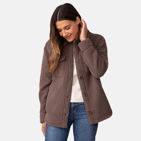 [Olga is 5'9" wearing a size Small.] Woman wearing Free Country Women's Sherpa Shacket in brown with a full front button opening, stand collar, chest pockets, and soft sherpa fabric. light grey background. Perfect women’s jacket for fall weather.