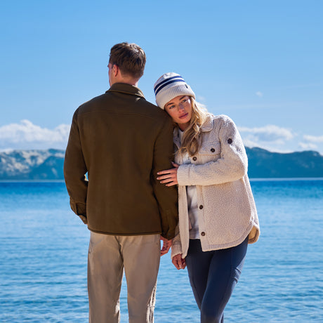Couple overlooking a mountain lake in cozy fleece jackets