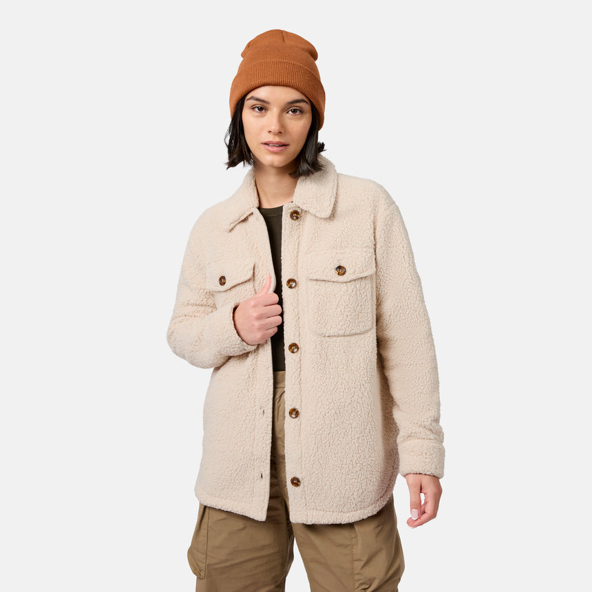 [Model is wearing size S.] A model wearing a beige sherpa fleece button-up jacket, a rust-colored beanie, and khaki pants, standing against a light gray studio background.