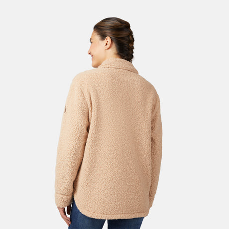 A woman with brown hair in a braid stands facing away, wearing a Free Country Women's Sherpa Shacket in an oversized fit with blue jeans, set against a plain white background.