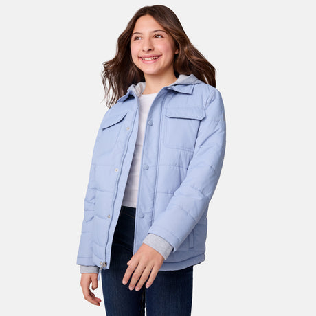[Samantha is wearing size M.] Women's Free Country light blue quilted jacket with button-up front, flap chest pockets, and side pockets—styled with dark blue jeans for a practical, cold-weather outfit.