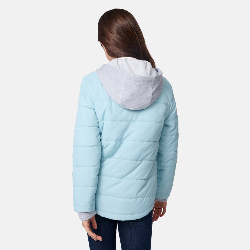 [Samantha is wearing size M.] Model wearing a Free Country light blue quilted jacket with button-front closure, flap chest pockets, and side pockets—layered over a white shirt with dark blue jeans for a casual, cold-weather look.