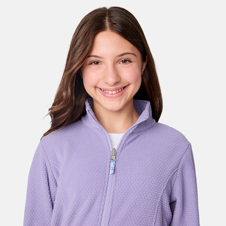 [Samantha is wearing size M.] Women's Free Country softshell jacket with floral upper print and solid lavender lower panels, featuring a zip-front closure and soft purple inner lining—designed for lightweight warmth and outdoor versatility.