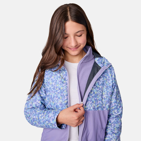 [Samantha is wearing size M.] Women's Free Country softshell jacket with floral upper print and solid lavender lower panels, featuring a zip-front closure and soft purple inner lining—designed for lightweight warmth and outdoor versatility.