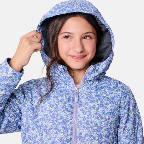 [Samantha is wearing size M.] Women's Free Country softshell jacket with floral upper print and solid lavender lower panels, featuring a zip-front closure and soft purple inner lining—designed for lightweight warmth and outdoor versatility.