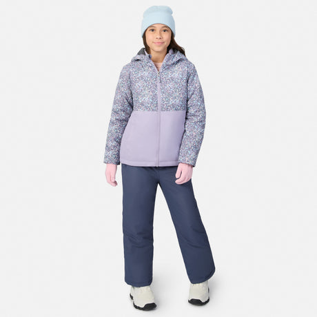 Back view of a girl in the Girls' 3-in-1 Systems Jacket showing lavender lower panel and patterned upper section with pink gloves and navy pants