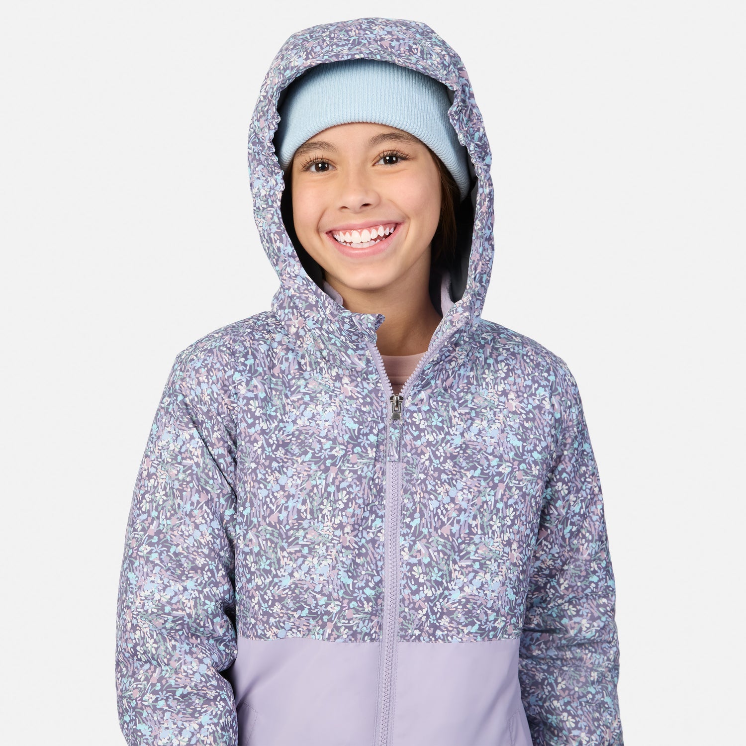 Girl wearing Girls' 3-in-1 Systems Jacket with lavender floral pattern and her hand in the pocket