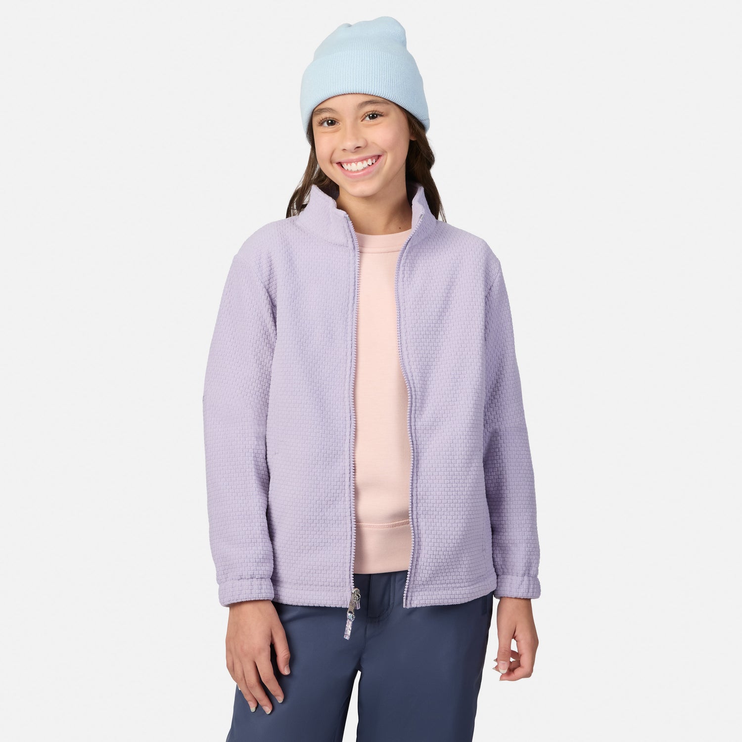 Smiling girl in a light blue beanie and lavender 3-in-1 jacket with pink inner layer