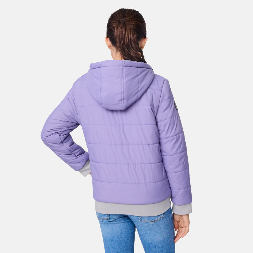 [Samantha is wearing size M.] Model wearing a Free Country light purple puffer jacket with zip-front closure, gray ribbed cuffs and hem, and matching hood—reverses to a casual gray hoodie for versatile styling, shown with relaxed blue jeans for a laid-back winter look.