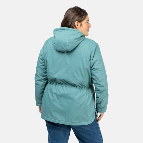 [Model is wearing a size 1X.] Woman wearing Free Country Women's Cascade Windshear Jacket in light blue with a full front zipper opening, soft lining, and water resistant and wind resistant recycled polyester stretch performance fabric, light grey background. Best women’s jacket for windy weather.