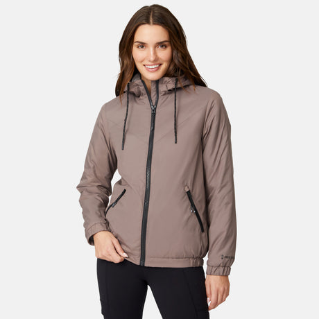 [Jessica is 5'9.5" wearing size S.] Free Country women’s light brown hooded jacket with black zippered pockets and drawstring hood—features plush sherpa lining for added insulation and comfort. Shown paired with black pants for a sleek, cold-weather outfit.