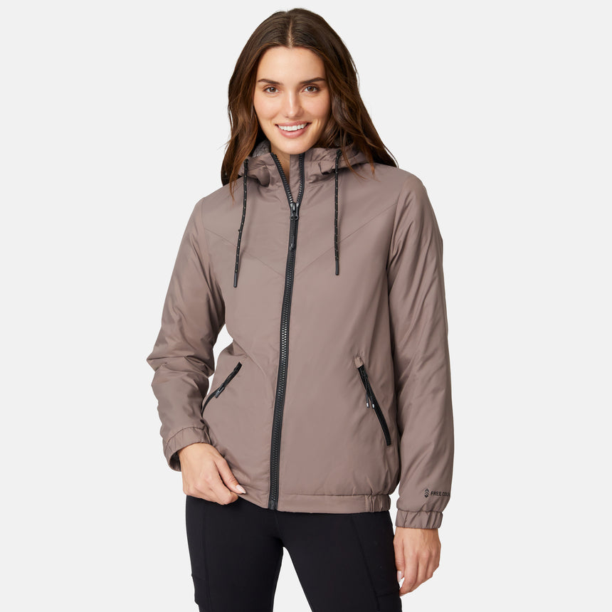 [Jessica is 5'9.5" wearing size S.] Free Country women’s light brown hooded jacket with black zippered pockets and drawstring hood—features plush sherpa lining for added insulation and comfort. Shown paired with black pants for a sleek, cold-weather outfit.