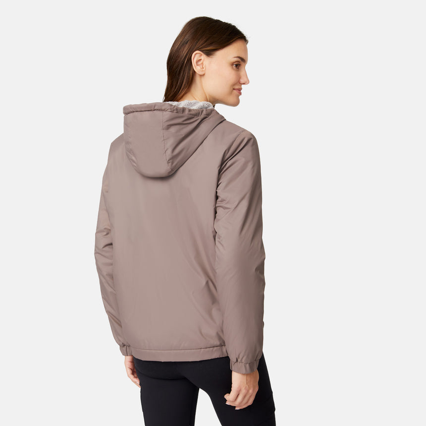 [Jessica is 5'9.5" wearing size S.] Free Country women’s light brown hooded jacket with black zippered pockets and drawstring hood—features plush sherpa lining for added insulation and comfort. Shown paired with black pants for a sleek, cold-weather outfit.