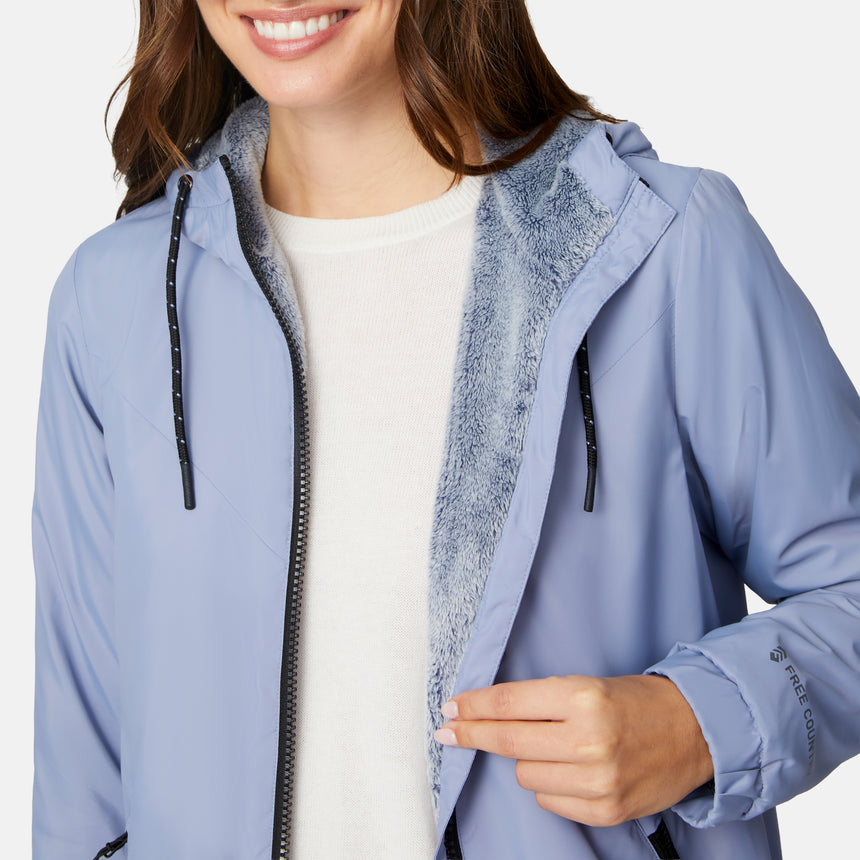 [Jessica is 5'9.5" wearing size S.] Women’s Free Country light blue hooded jacket with full-zip closure, zippered side pockets, and drawstring hood—sherpa lined for added warmth and comfort. Paired with blue jeans for a cozy, cold-weather look.
