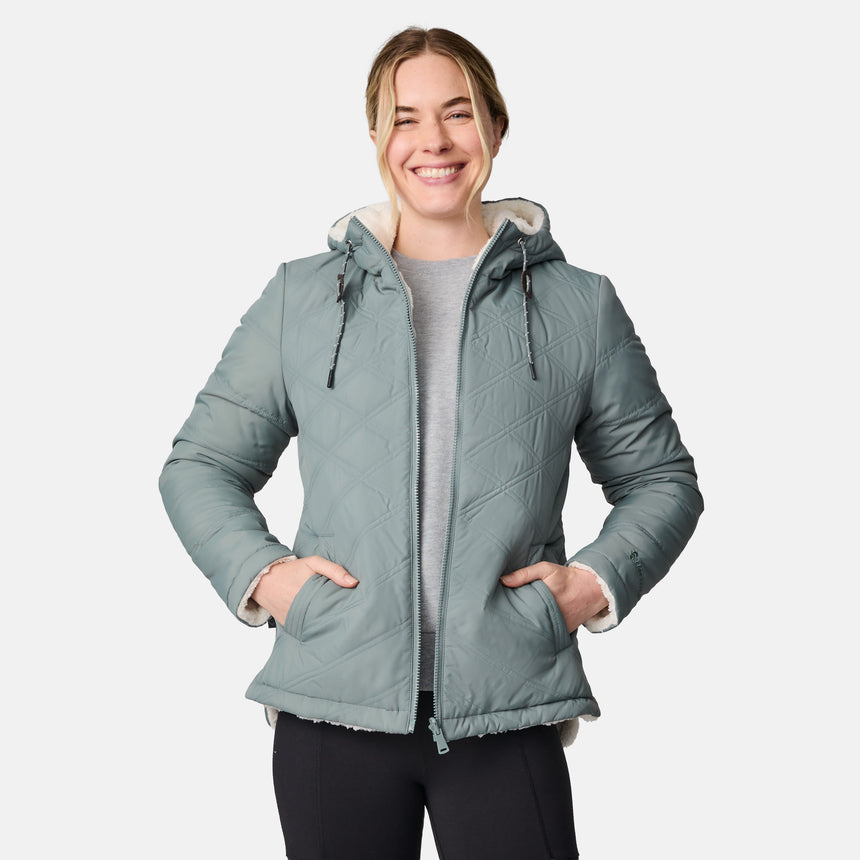 [CJ is 5'10" wearing size S.] Women’s Free Country light green quilted hooded jacket with full-zip closure, drawstring hood, and dual hand pockets—reversible to cozy sherpa for added warmth and comfort. Paired with jeans and a casual top for a laid-back, cold-weather look.