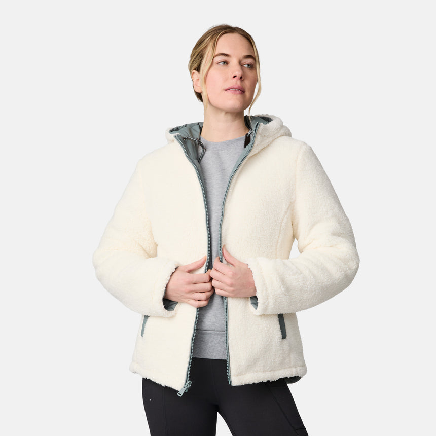 [CJ is 5'10" wearing size S.] Women’s Free Country light green quilted hooded jacket with full-zip closure, drawstring hood, and dual hand pockets—reversible to cozy sherpa for added warmth and comfort. Paired with jeans and a casual top for a laid-back, cold-weather look.