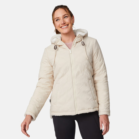[Emily is 5'9" wearing size S.] Women’s Free Country cream-colored quilted hooded jacket with full-zip closure, drawstring hood, and dual hand pockets—reversible to cozy sherpa for versatile styling and added cold-weather comfort. Styled with jeans for a relaxed, outdoorsy look.