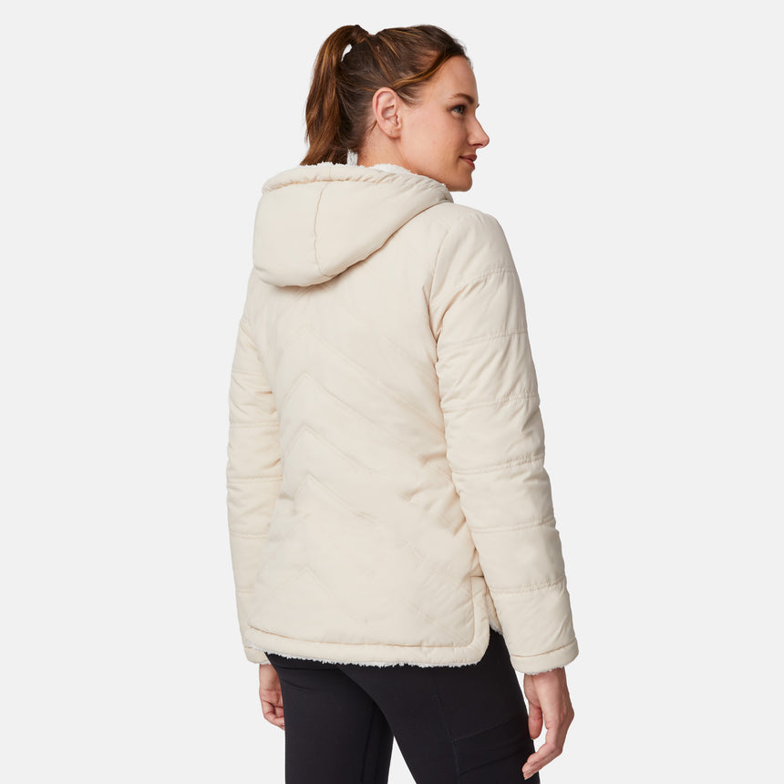 [Emily is 5'9" wearing size S.] Women’s Free Country cream-colored quilted hooded jacket with full-zip closure, drawstring hood, and dual hand pockets—reversible to cozy sherpa for versatile styling and added cold-weather comfort. Styled with jeans for a relaxed, outdoorsy look.