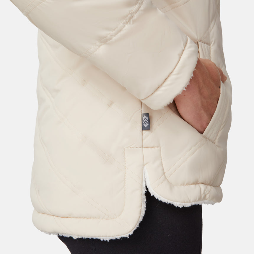 [Emily is 5'9" wearing size S.] Women’s Free Country cream-colored quilted hooded jacket with full-zip closure, drawstring hood, and dual hand pockets—reversible to cozy sherpa for versatile styling and added cold-weather comfort. Styled with jeans for a relaxed, outdoorsy look.