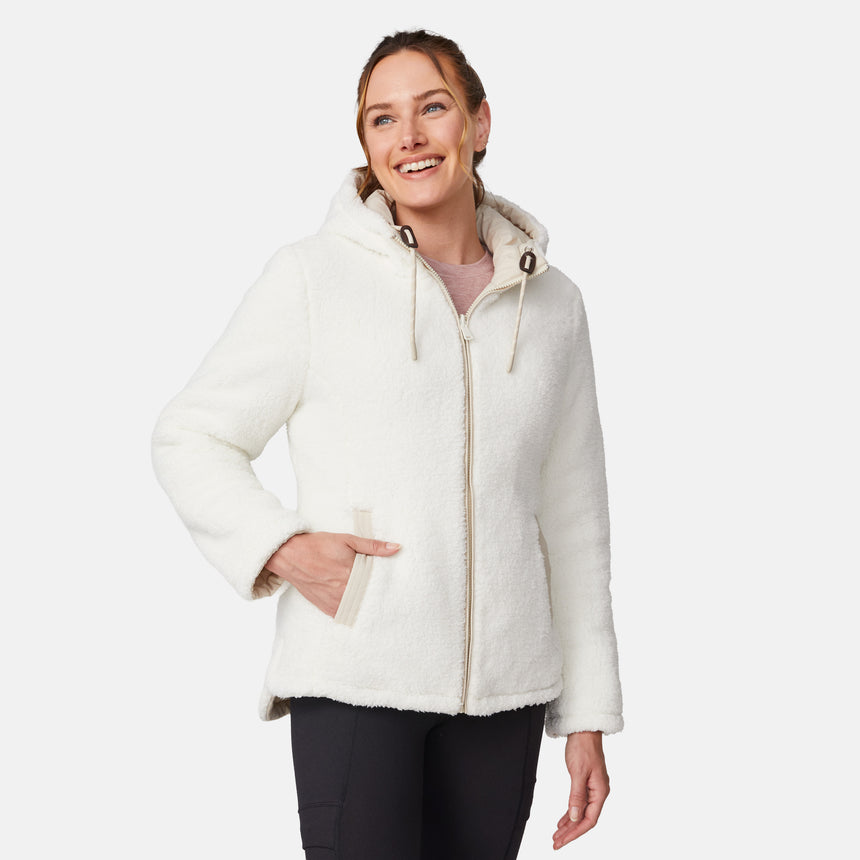 [Emily is 5'9" wearing size S.] Women’s Free Country cream-colored quilted hooded jacket with full-zip closure, drawstring hood, and dual hand pockets—reversible to cozy sherpa for versatile styling and added cold-weather comfort. Styled with jeans for a relaxed, outdoorsy look.