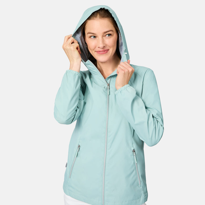 Woman wearing a light green raincoat on a white background