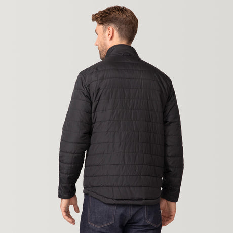 A man with short brown hair, seen from behind, is wearing the Men's FreeCycle® Jack Frost 3-in-1 Systems Jacket by Clearance in black and dark blue jeans against a plain light gray background.