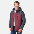 [Kolby is 6'2" wearing size M.] Men’s Free Country jacket with maroon body and contrasting charcoal gray sleeves, hood, and shoulders—featuring a zippered chest pocket and full-length front zip. Worn over a white crew neck shirt and blue jeans. Engineered for transitional weather layering with eye-catching two-tone design.