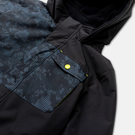 Close-up of the Free Country Boys' Multi Rip Stop Boarder Jacket, featuring a hood, blue camo chest pocket, and yellow snap button. This recycled polyester jacket offers water resistance and a sporty look for kids.