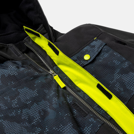 Close-up of the Free Country Boys' Multi Rip Stop Boarder Jacket in black and blue pattern with zippered front, bright yellow lining, yellow snap button, Velcro strips, hood—crafted from recycled polyester.