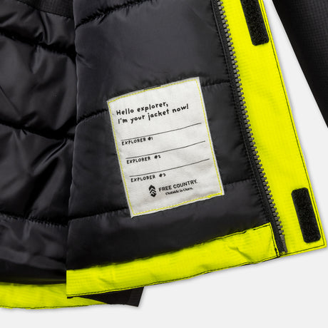 A close-up of the inside of the Free Country Boys' Multi Rip Stop Boarder Jacket, made from recycled polyester, shows a patch that says "Hello explorer, I'm your jacket now!" and space for "Explorer #" above the logo on this water-resistant jacket.