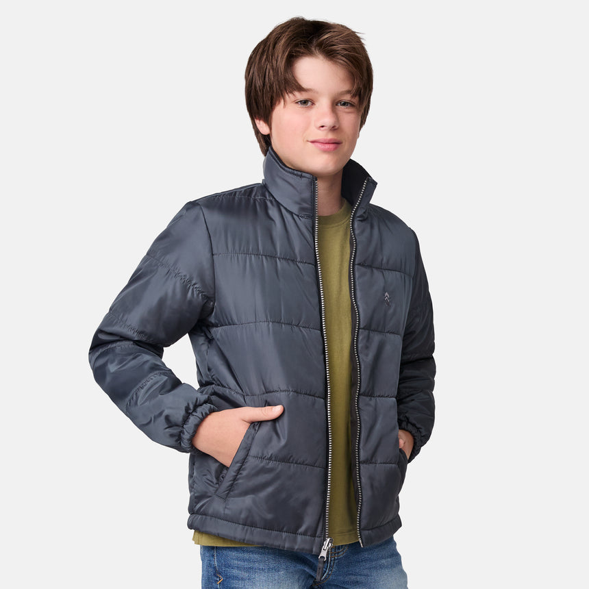 [River is wearing size M.] Boys' black 3-in-1 jacket with zip-out puffer liner and hood — versatile cold-weather system with chest logo and multiple pockets