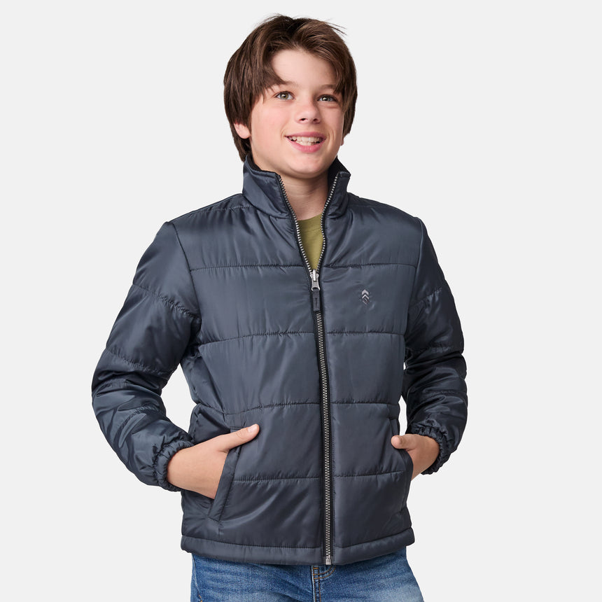 [River is wearing size M.] Boys' black 3-in-1 jacket with zip-out puffer liner and hood — versatile cold-weather system with chest logo and multiple pockets