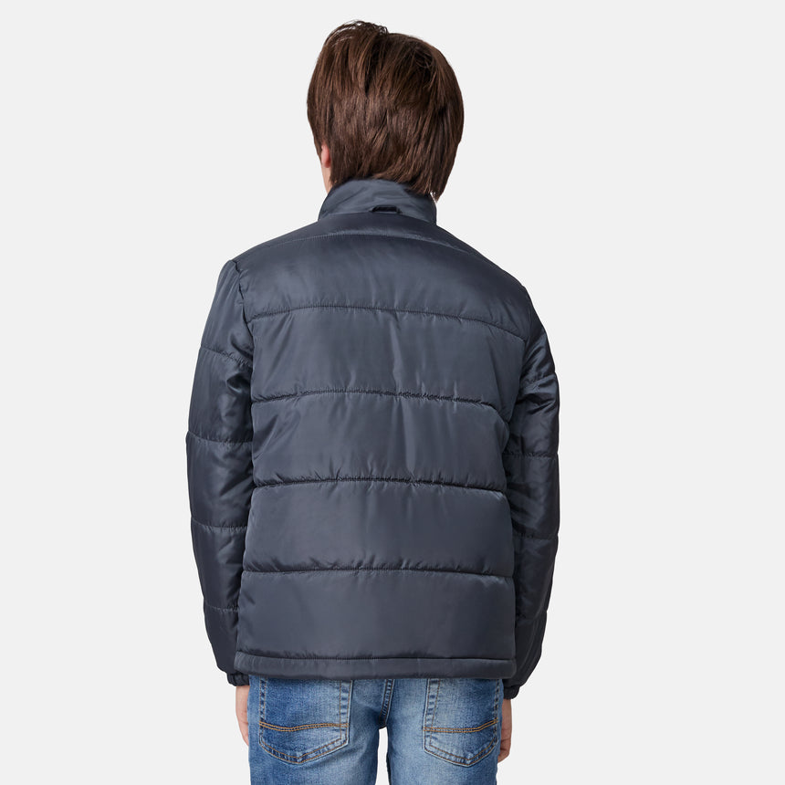 [River is wearing size M.] Boys' black 3-in-1 jacket with zip-out puffer liner and hood — versatile cold-weather system with chest logo and multiple pockets