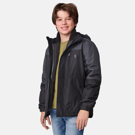 [River is wearing size M.] Boys' black 3-in-1 jacket with zip-out puffer liner and hood — versatile cold-weather system with chest logo and multiple pockets