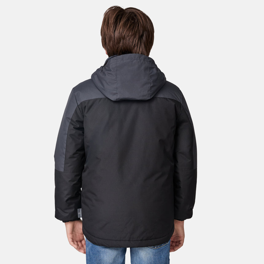[River is wearing size M.] Boys' black 3-in-1 jacket with zip-out puffer liner and hood — versatile cold-weather system with chest logo and multiple pockets