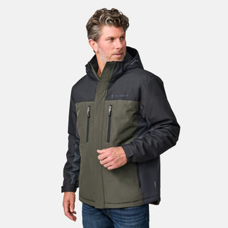 [Kolby is 6'2" wearing size M.]  "Men’s Free Country two-tone zip-front jacket with black upper section and olive green lower panels—features dual vertical zippered chest pockets, side hand pockets, and attached hood. Layered over a green crewneck tee and blue jeans for versatile, outdoor-ready style.