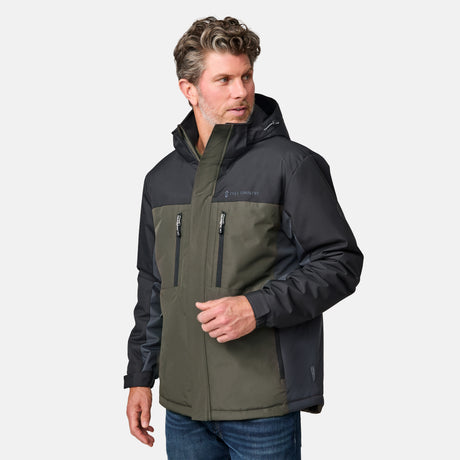 [Kolby is 6'2" wearing size M.]  "Men’s Free Country two-tone zip-front jacket with black upper section and olive green lower panels—features dual vertical zippered chest pockets, side hand pockets, and attached hood. Layered over a green crewneck tee and blue jeans for versatile, outdoor-ready style.