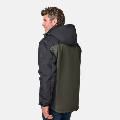 [Kolby is 6'2" wearing size M.]  "Men’s Free Country two-tone zip-front jacket with black upper section and olive green lower panels—features dual vertical zippered chest pockets, side hand pockets, and attached hood. Layered over a green crewneck tee and blue jeans for versatile, outdoor-ready style.